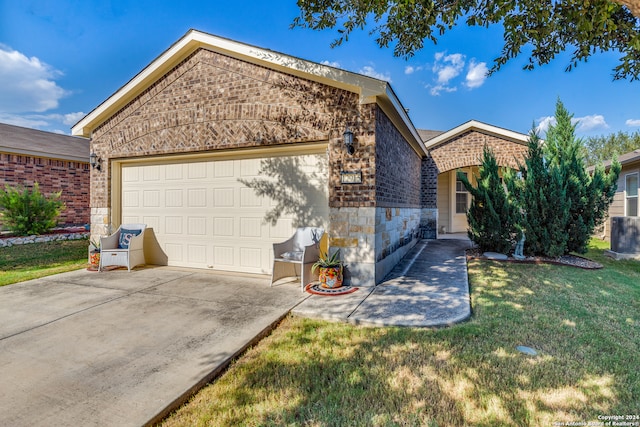 view of front of house with a garage and a front lawn