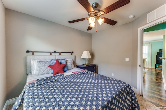 bedroom with ceiling fan and wood-type flooring