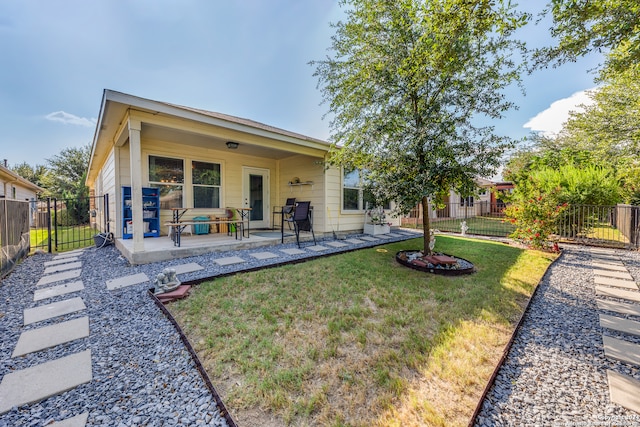 back of property featuring a lawn and a patio area