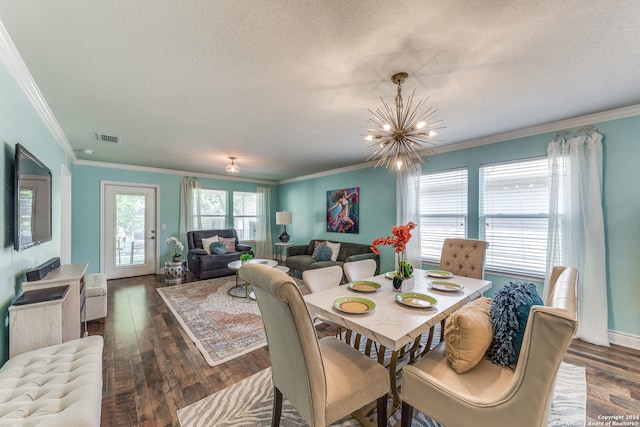 dining room with a notable chandelier, a textured ceiling, dark hardwood / wood-style flooring, and ornamental molding