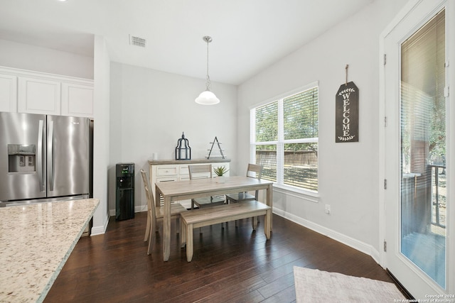 dining space with dark hardwood / wood-style flooring