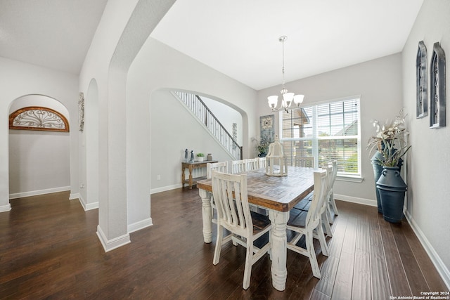 dining area featuring an inviting chandelier and dark wood-type flooring