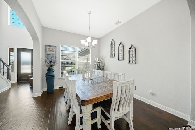 dining area with dark hardwood / wood-style flooring and a chandelier