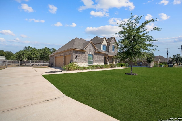 view of front facade with a front lawn and a garage