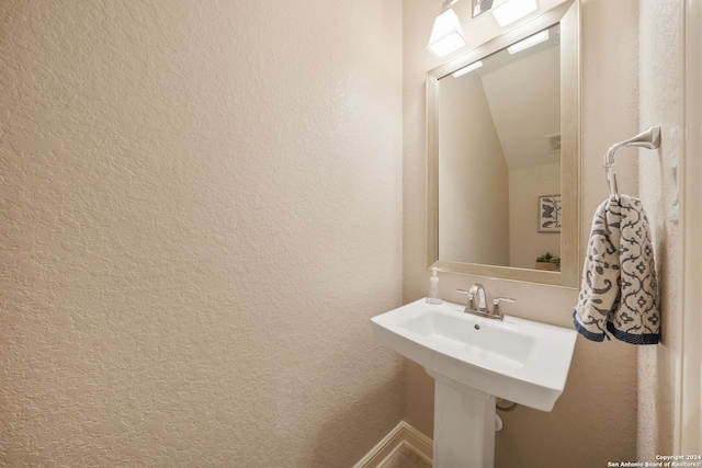 bathroom with vaulted ceiling