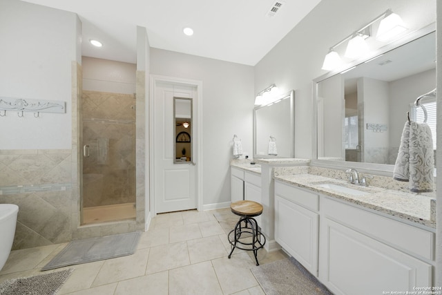 bathroom featuring tile patterned floors, vanity, and walk in shower