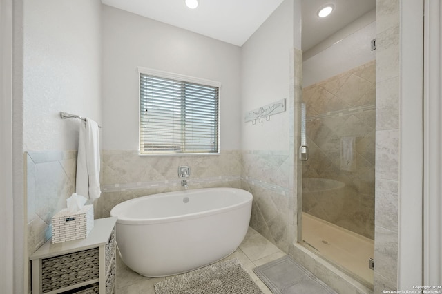 bathroom featuring tile walls, separate shower and tub, and tile patterned floors