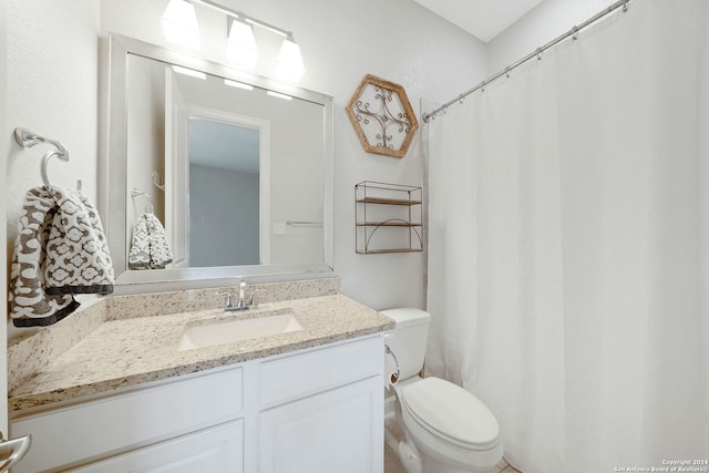 bathroom with a shower with shower curtain, toilet, and vanity