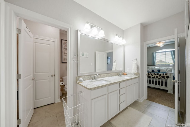 bathroom with ceiling fan, toilet, vanity, and tile patterned floors