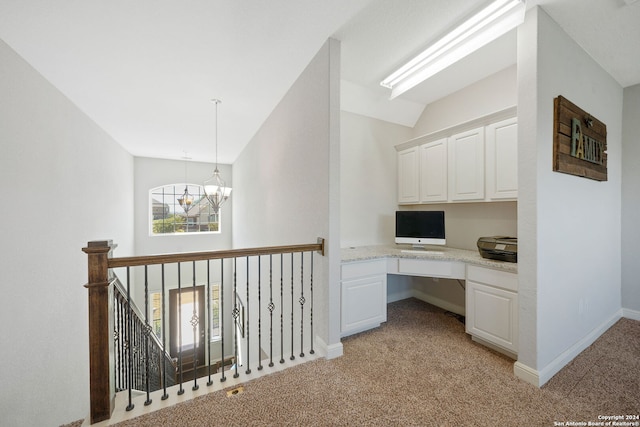 interior space with vaulted ceiling, a notable chandelier, and light colored carpet