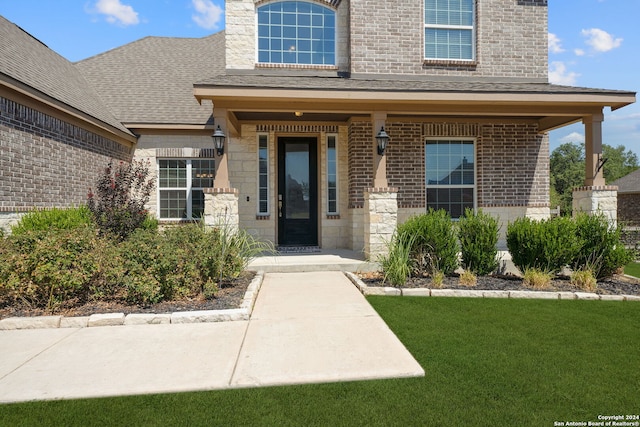 view of exterior entry with a yard