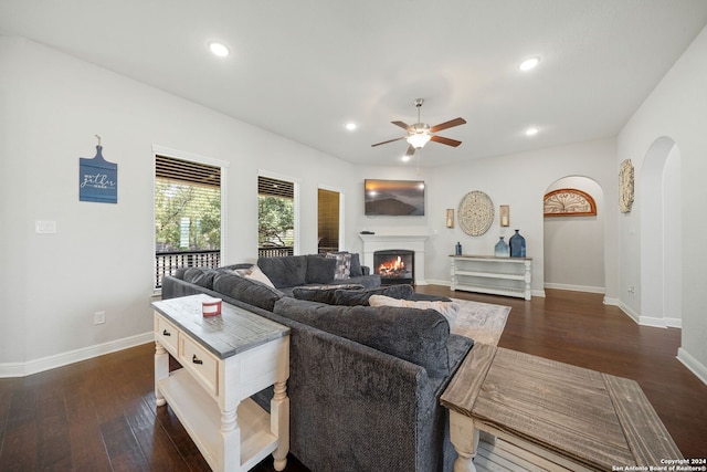 living room with ceiling fan and dark hardwood / wood-style floors