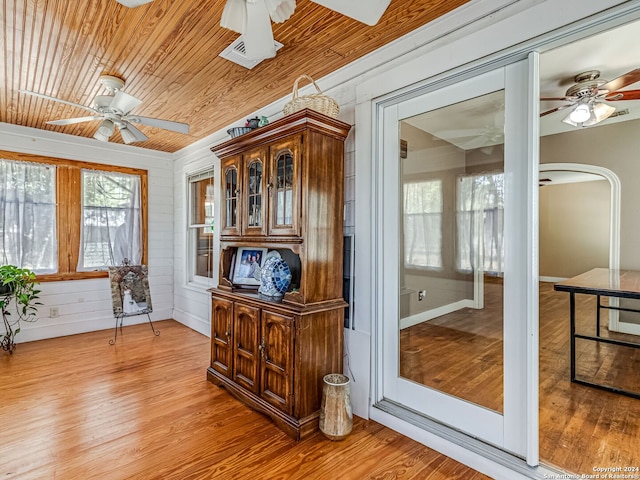 doorway featuring ceiling fan, light hardwood / wood-style flooring, and wooden ceiling