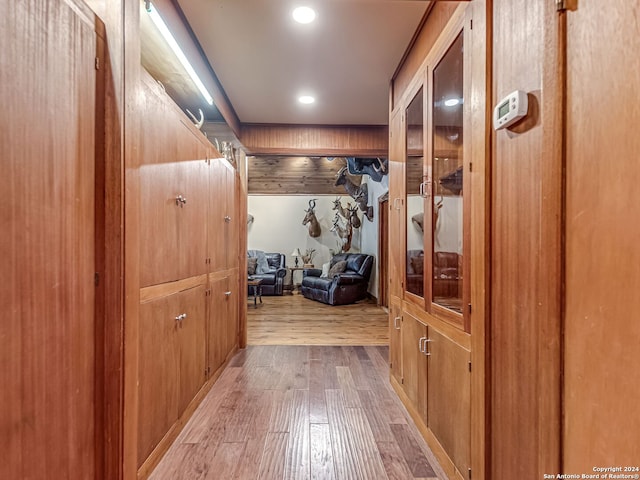 mudroom featuring wooden walls and wood-type flooring