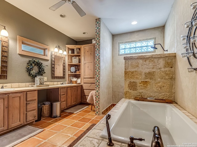 bathroom featuring tile patterned floors, a washtub, vanity, and ceiling fan