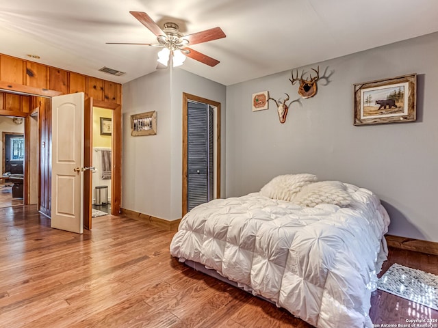 bedroom featuring ceiling fan, a closet, and hardwood / wood-style floors