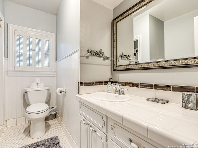 bathroom featuring toilet, vanity, and tile patterned floors