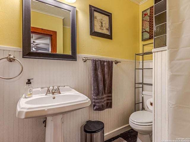 bathroom with crown molding and toilet