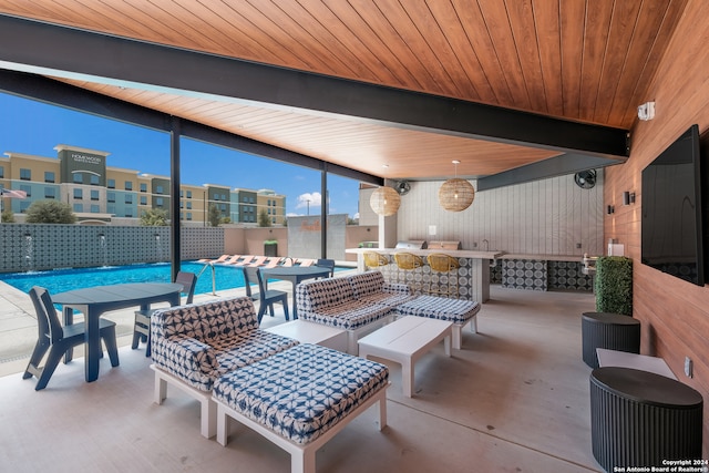 view of patio / terrace with pool water feature, a community pool, and a bar