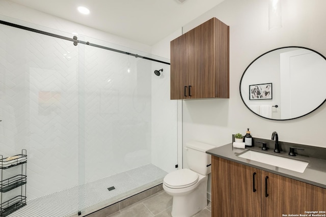 bathroom featuring toilet, tile patterned flooring, vanity, and a shower stall