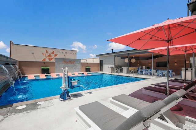 community pool featuring a patio area and fence