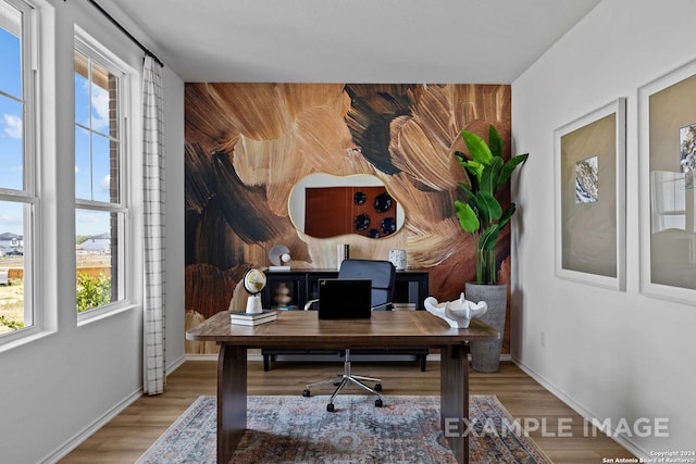 office area with wood walls, hardwood / wood-style flooring, and plenty of natural light