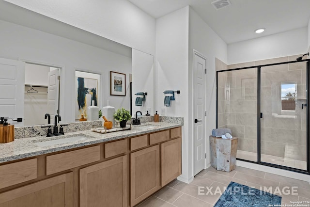 bathroom featuring vanity, tile patterned floors, and an enclosed shower