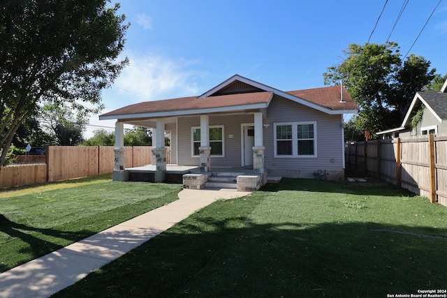 bungalow-style house with a front lawn