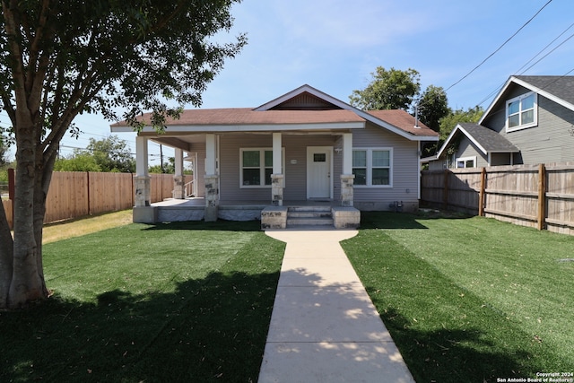 bungalow-style home featuring a porch and a front yard