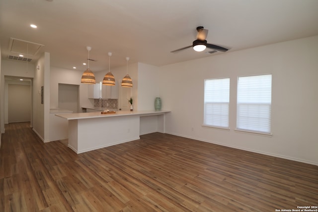 kitchen with white cabinetry, kitchen peninsula, and dark hardwood / wood-style floors