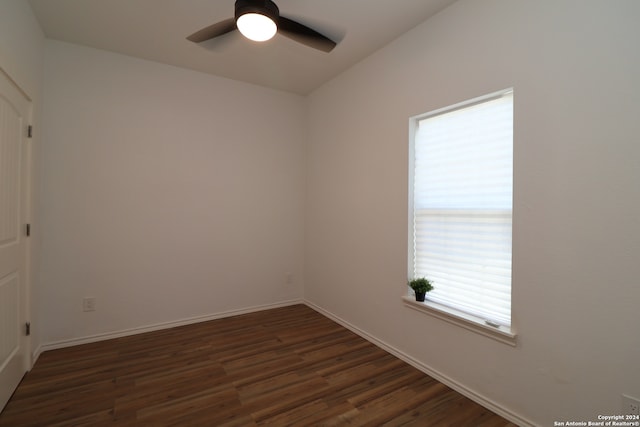 empty room with ceiling fan and dark wood-type flooring