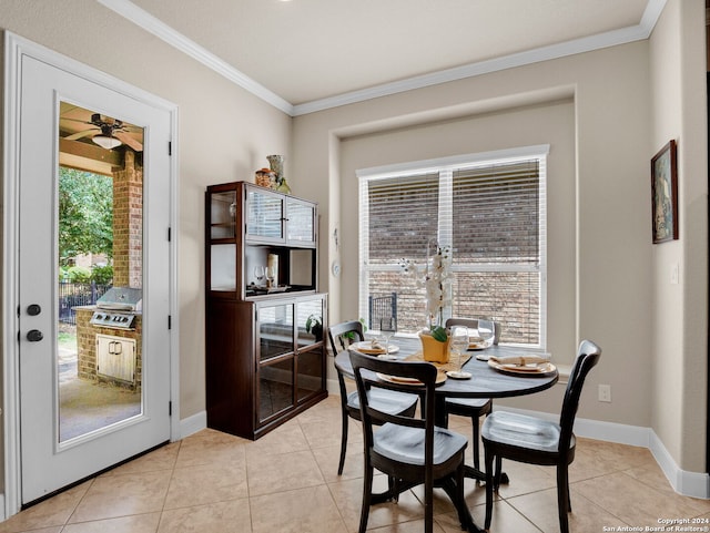 dining space with light tile patterned floors, baseboards, and crown molding