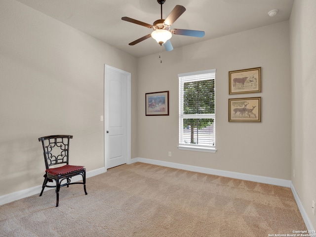 living area featuring ceiling fan and light colored carpet