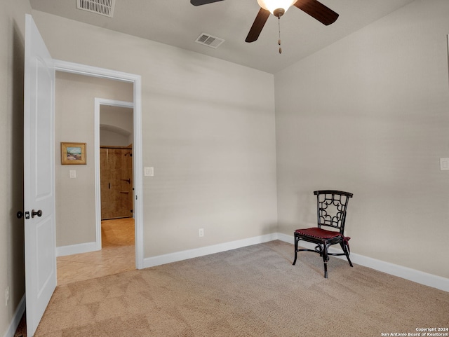 unfurnished room featuring ceiling fan and light colored carpet