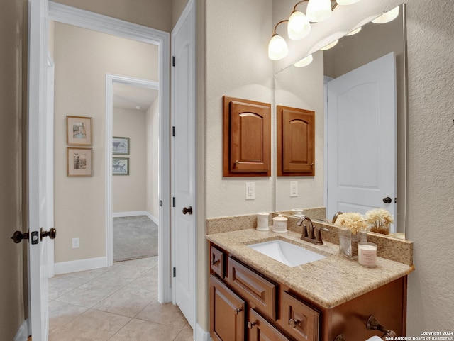 bathroom featuring tile patterned flooring and vanity