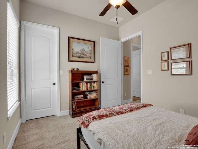 bedroom with ceiling fan and light carpet