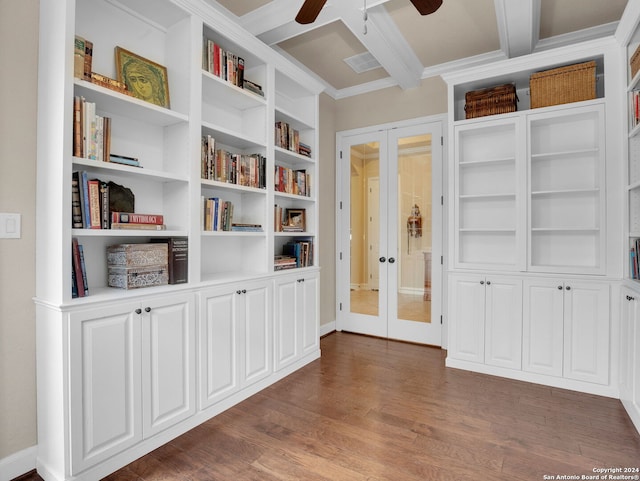 interior space with ceiling fan, built in shelves, dark wood-type flooring, beam ceiling, and french doors