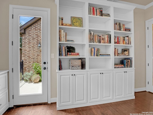 interior space featuring hardwood / wood-style flooring and built in shelves