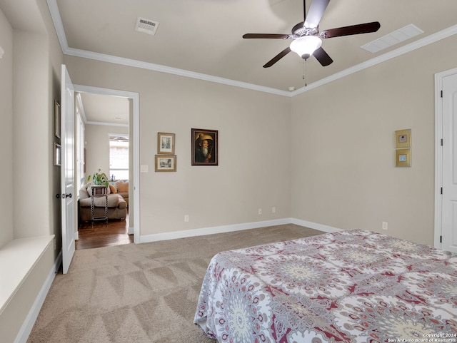 bedroom featuring baseboards, visible vents, crown molding, and light colored carpet