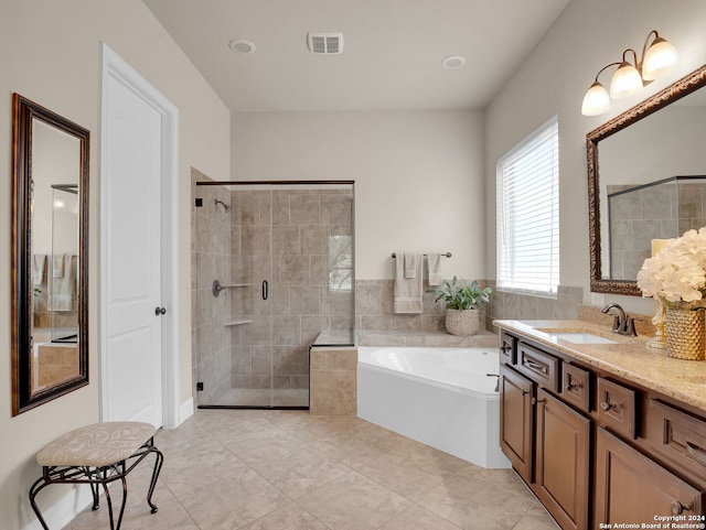 bathroom with tile patterned floors, independent shower and bath, and vanity