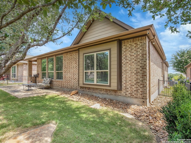 back of property featuring a patio and a lawn