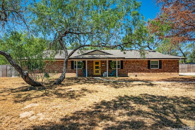 ranch-style home featuring a front yard