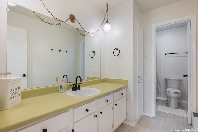 bathroom featuring tile patterned flooring, toilet, and vanity