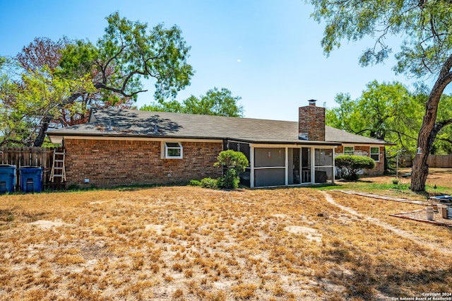 back of house featuring a sunroom