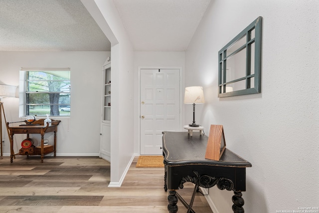 entryway featuring a textured ceiling and hardwood / wood-style floors