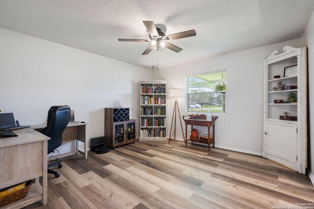 office featuring baseboards, a ceiling fan, a textured ceiling, and wood finished floors