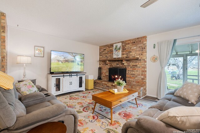 living area featuring a fireplace and a textured ceiling