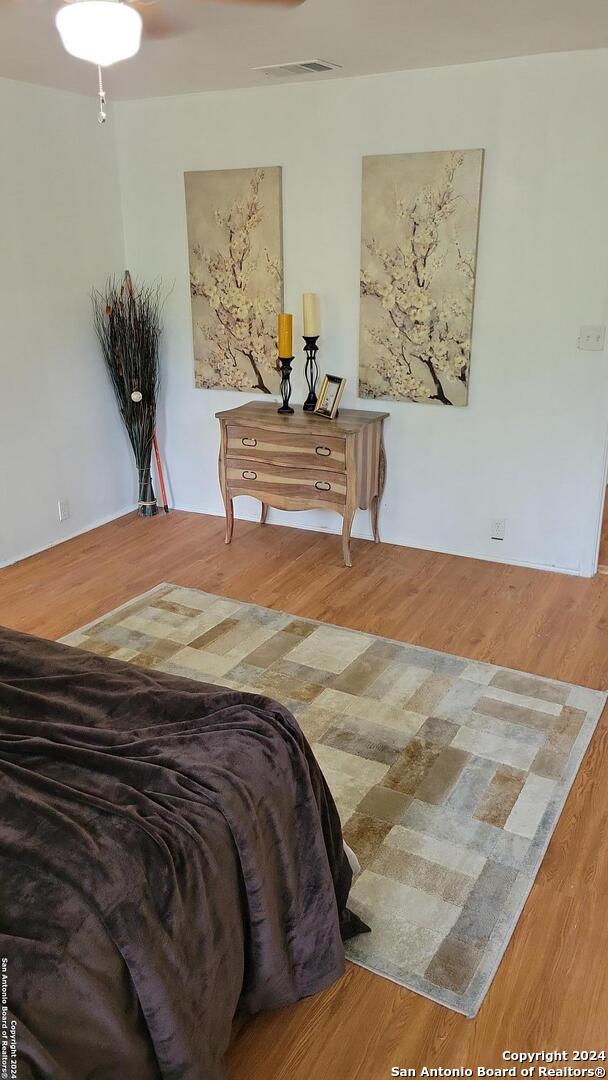 bedroom with hardwood / wood-style floors