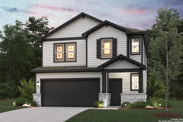 craftsman-style home with a yard and a garage