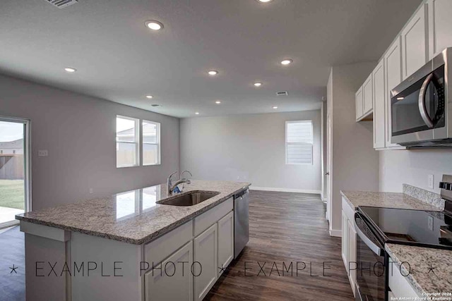 kitchen with appliances with stainless steel finishes, dark hardwood / wood-style flooring, sink, a center island with sink, and white cabinets